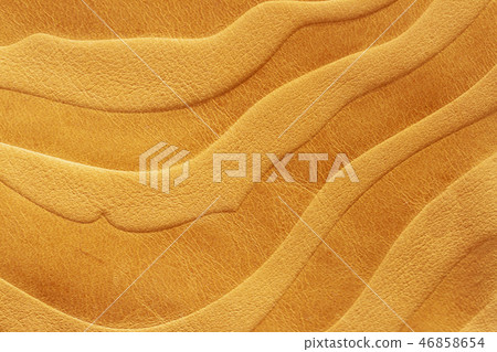 Texture of golden yellow genuine leather close-up, with stamped pattern, wallpaper or banner design 46858654