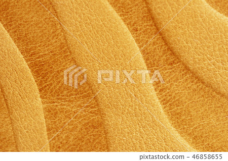 Texture of golden yellow genuine leather close-up, with embossed pattern, wallpaper or banner design 46858655