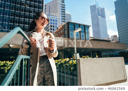 female student holding coffee cup enjoy sunshine female student holding coffee cup enjoy sunshine 46862569