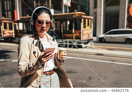 Happy teenager listening music wearing headphones 46862576