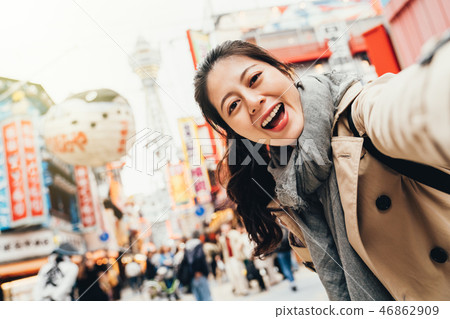 traveler cheerfully taking selfie in tsutenkaku traveler cheerfully taking selfie in tsutenkaku 46862909