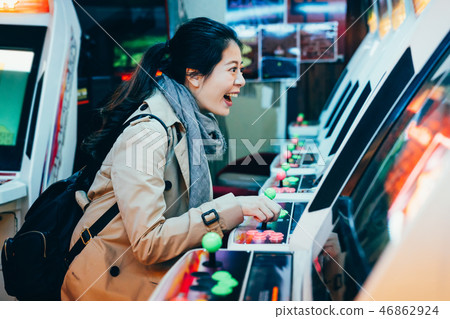 young girl backpacker playing game machine 46862924