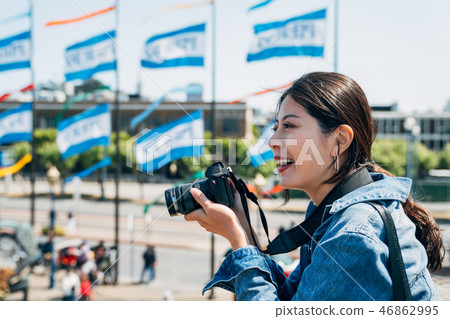 happy woman photographer joyfully taking picture 46862995