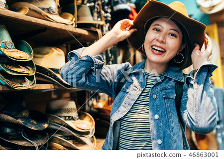 asian girl trying trilby in the cowboy shop 46863001