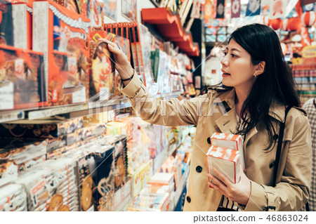 asian girl traveler visiting local specialty shop