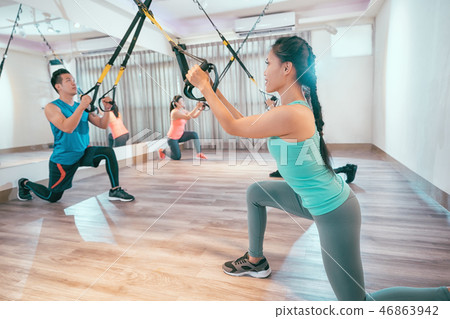 young people are training indoors with TRX 46863942