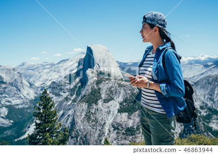traveler holding cellphone checking the location 46863944
