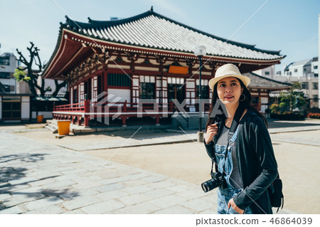 Happy lady traveler visit shitennoji 46864039