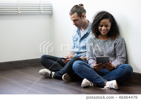 Young Couple using smartphone and digital tablet. 46864476