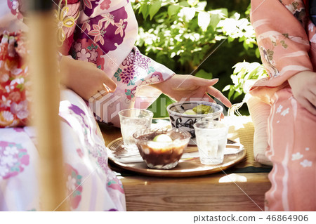 The hands of two women in a kimono wearing sweetness in a teahouse The hands of two women in a kimono wearing sweetness in a teahouse 46864906