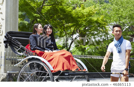 Two high school girls in a rickshaw stopping 46865113