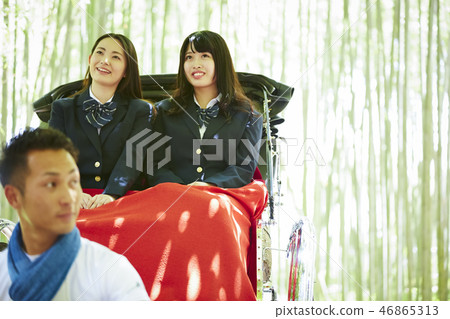 Two high school girls riding a rickshaw in a bamboo forest Two high school girls riding a rickshaw in a bamboo forest 46865313