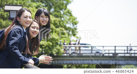 Three high school girls who lean against the background of Togetsu Bridge 46865424