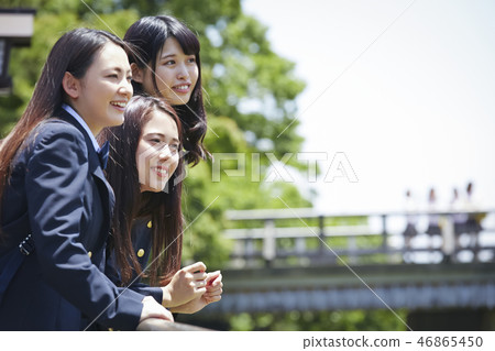 Three high school girls who lean against the background of Togetsu Bridge 46865450