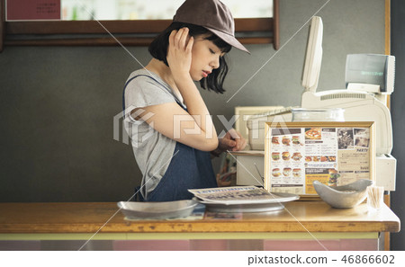 A woman working in a cafe A woman working in a cafe 46866602