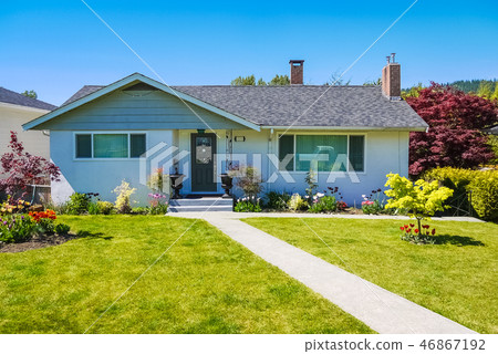 Average family house with concrete pathway over the yard 46867192
