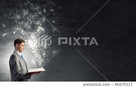 Businessman with opened book Businessman with opened book 46870521