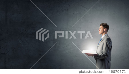 Businessman with opened book Businessman with opened book 46870571