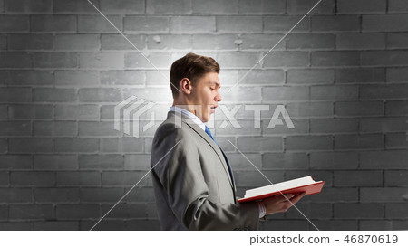 Businessman with opened book 46870619