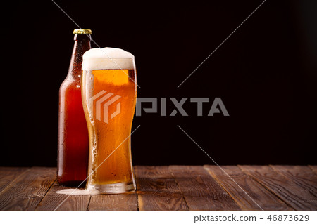 Photo of buttle and glass of beer Photo of buttle and glass of beer 46873629