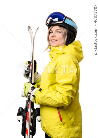 Smiling girl in helmet holding skis 46873707