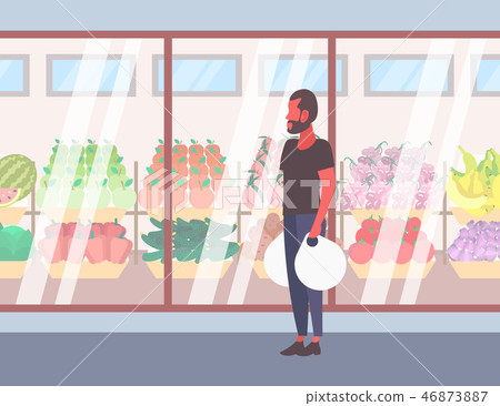 casual man holding shopping bags walking in front of fresh organic fruits vegetables modern 46873887