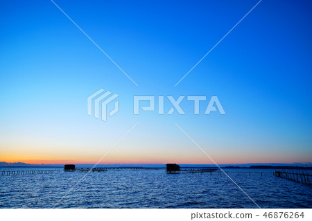 Morning glow of Kasumigaura and aquaculture cage of carp Morning glow of Kasumigaura and aquaculture cage of carp 46876264
