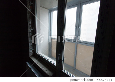 Unfinished building interior, gray room. Repairs in the apartment. Preparing in the room 46878744