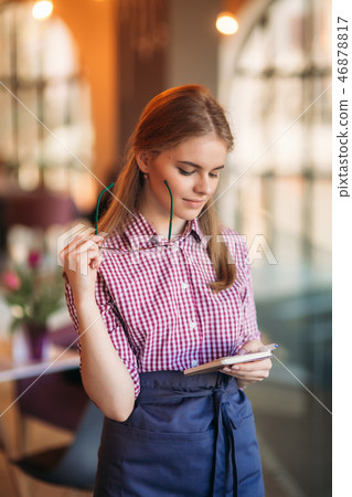 Portrait of a beautiful friendly waitress in glasses with notepapers and pen ready to take your Portrait of a beautiful friendly waitress in glasses with notepapers and pen ready to take your 46878817