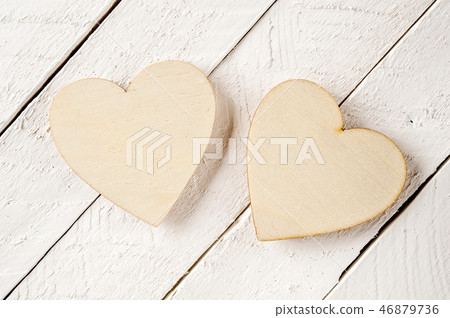 Two wood heart on a vintage wooden background. 46879736