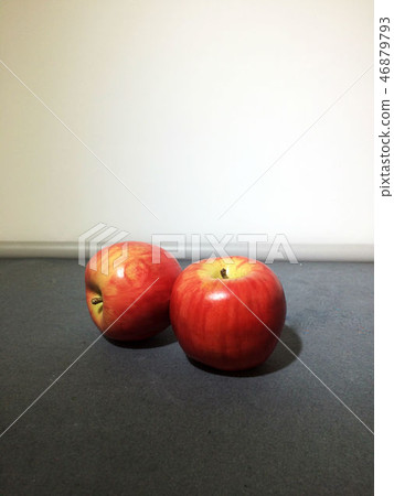 Two red apples on table 46879793