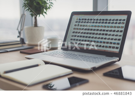 Workplace with notebook laptop Comfortable work table in office windows and city view. Workplace with notebook laptop Comfortable work table in office windows and city view. 46881843