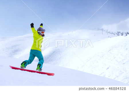 Snowboarder running down slope Snowboarder running down slope 46884328