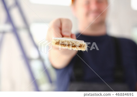 Arm of smiling worker hold brush closeup Arm of smiling worker hold brush closeup 46884691
