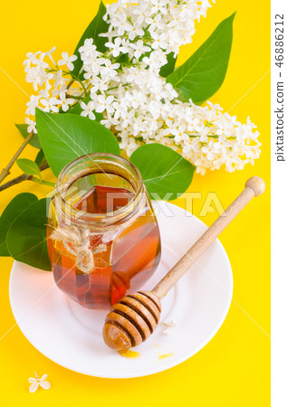 Glass jar with floral aromatic honey 46886212