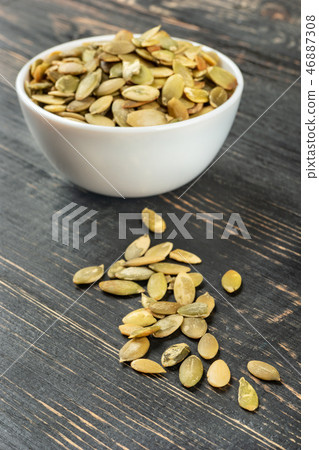 Pumpkin seed kernels in bowl 46887308