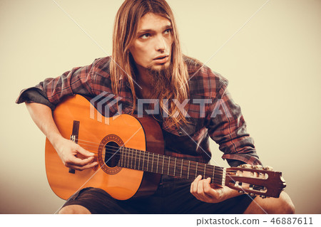 Sitting man playing guitar. Sitting man playing guitar. 46887611