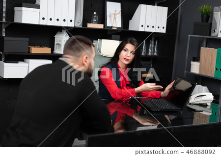 Business people look at blank laptop screen at meeting in stylish office 46888092