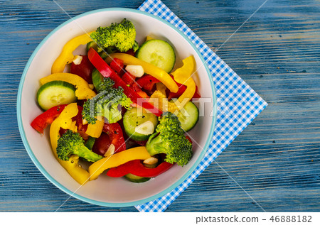 Summer vegetarian fresh vegetable salad on blue Summer vegetarian fresh vegetable salad on blue 46888182