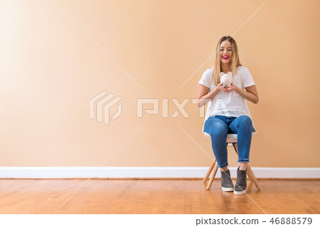 Young woman with a piggy bank Young woman with a piggy bank 46888579