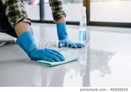 Husband housekeeping and cleaning concept, Happy young man in bl Husband housekeeping and cleaning concept, Happy young man in bl 46889830