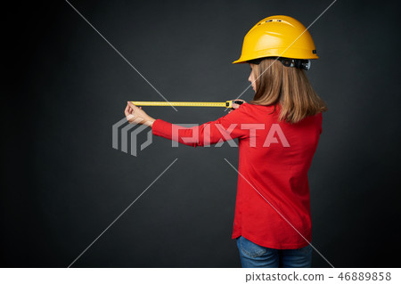 Decoration, renovation and reconstrucion concept. Girl with measuring tape 46889858