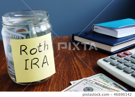 Roth ira written on a label of the jar with money. 46890142
