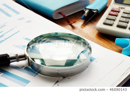 Business audit. Magnifying glass on documents. 46890143