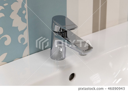 Fragment of conventional faucet in the bathroom 46890943