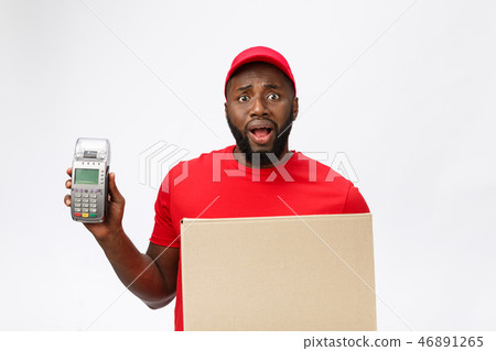 Happy young African American delivery man holding up an electronic card payment machine and delivery Happy young African American delivery man holding up an electronic card payment machine and delivery 46891265