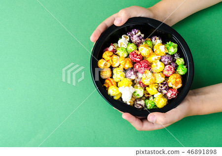 Colorful popcorn in children's hands 46891898