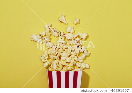 Full of popcorn in classic striped box on color ba Full of popcorn in classic striped box on color ba 46891997