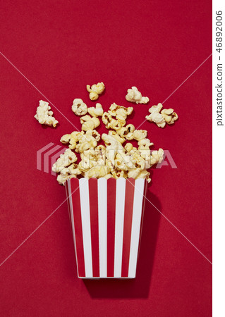 Full of popcorn in classic striped box on color ba Full of popcorn in classic striped box on color ba 46892006
