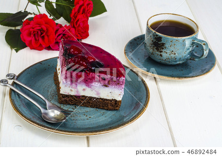 Piece of jelly mousse cake with fruit, cup of tea Piece of jelly mousse cake with fruit, cup of tea 46892484